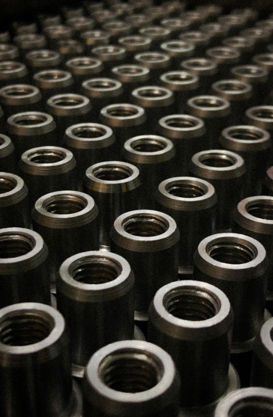 a-large-group-of-metal-flanges-sitting-on-top-of-a-table.jpg a large group of metal flanges sitting on top of a table