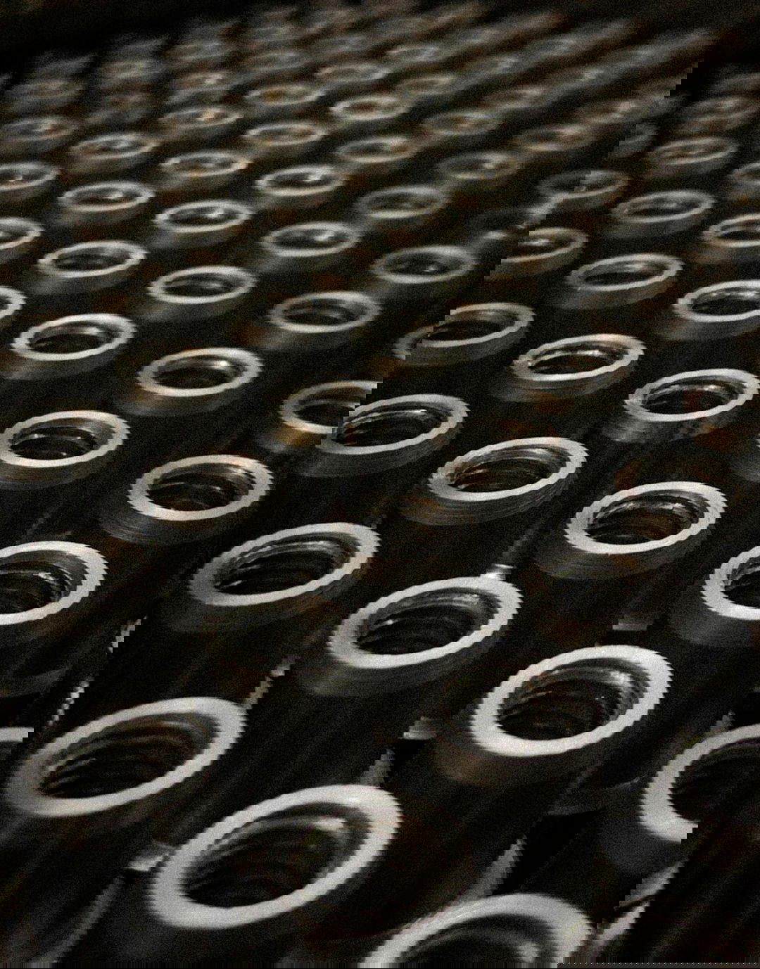 a large group of metal flanges sitting on top of a table